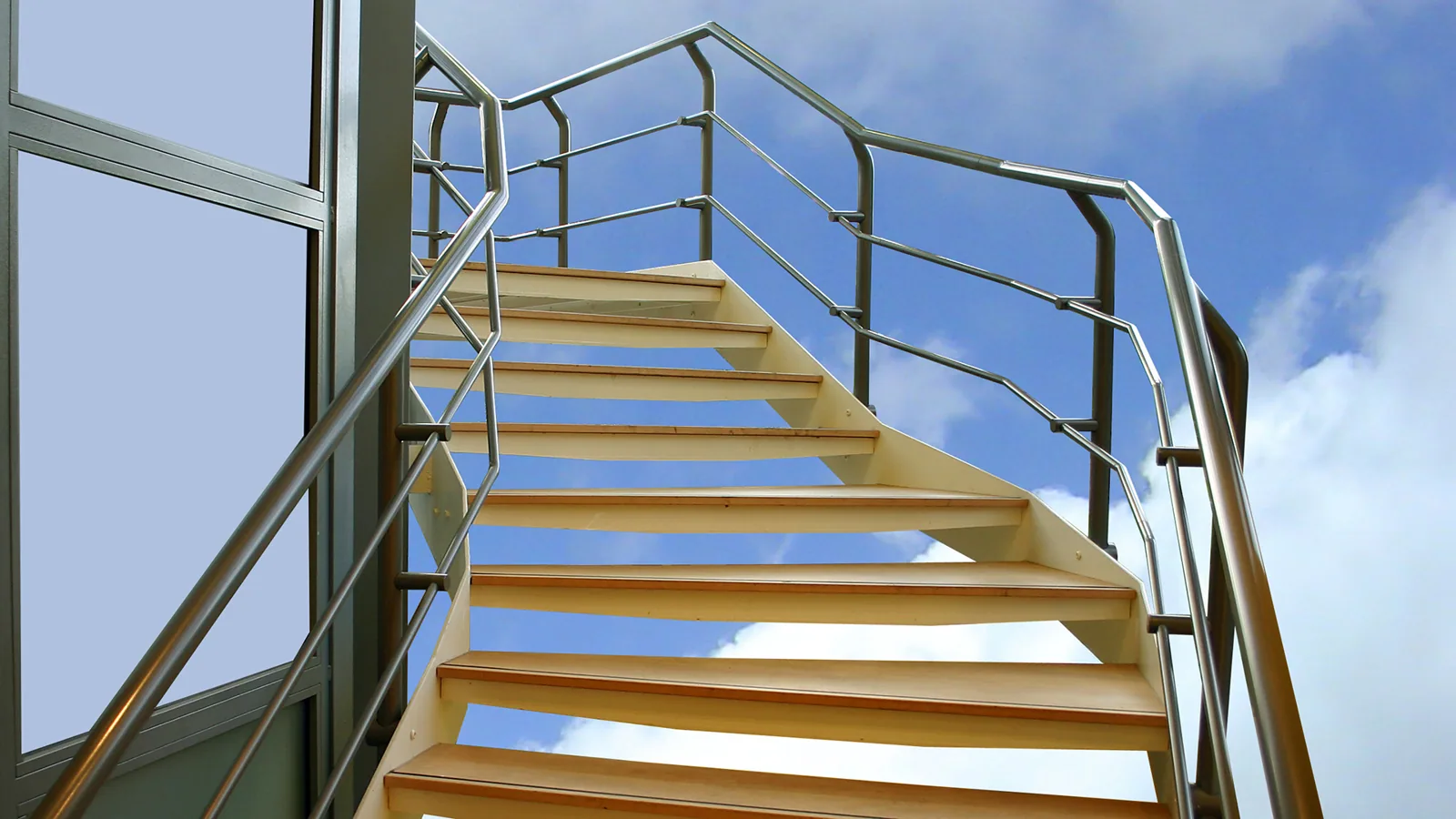 Stainless balustrade and handrails surrounding exterior steel stairs