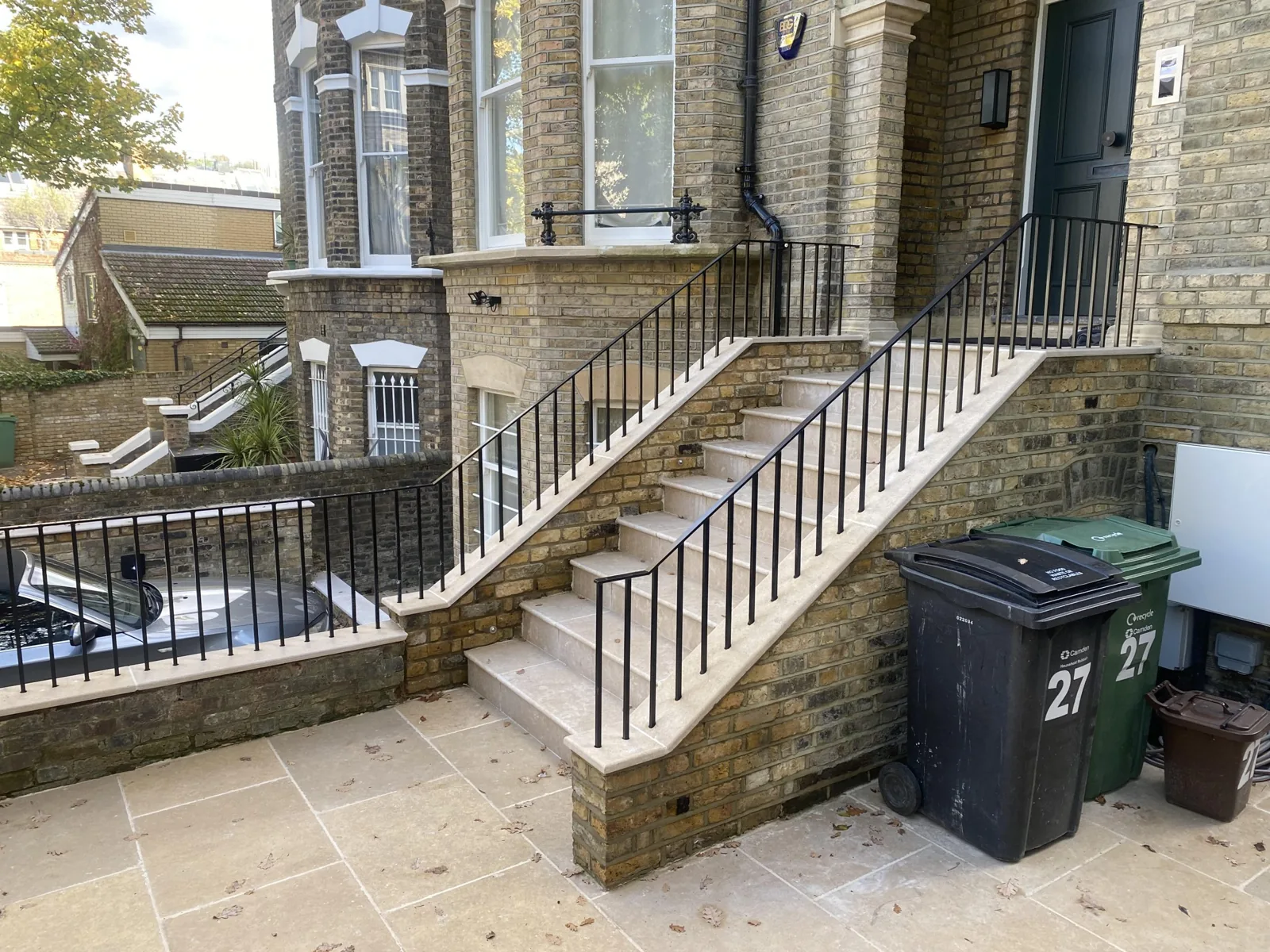 Black steel handrails and balustrade on stone entrance steps at a Hampstead house, fabricated by MAH Steel