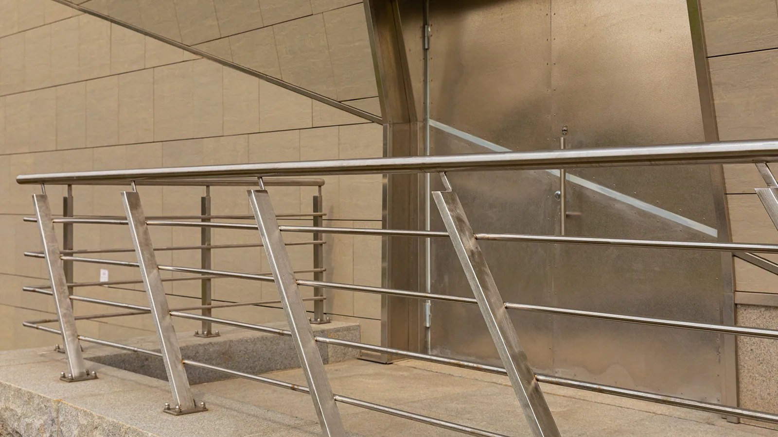 Stainless guardrail and upright posts along an industrial walkway