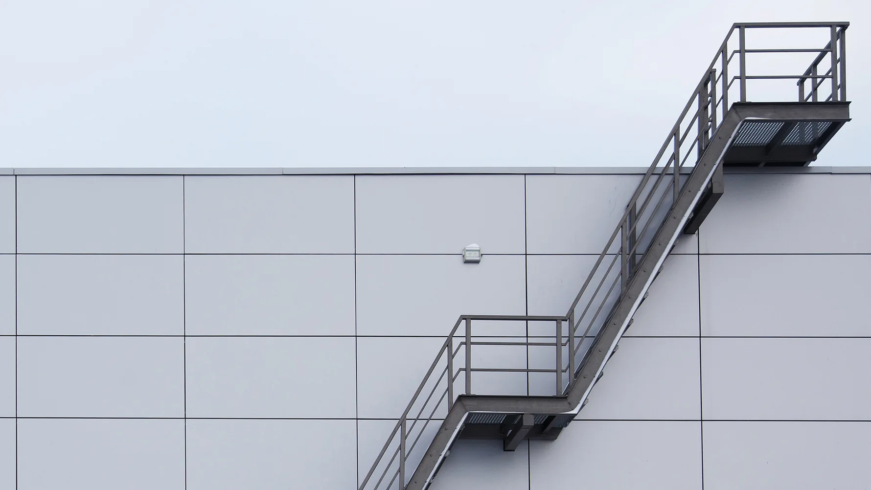 External steel fire escape stair on the outside of an industrial building