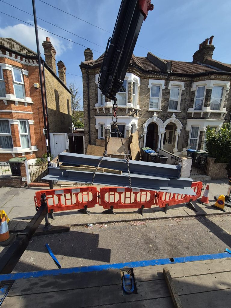 steel structure assembly, extension steel delivery, lifting steel beams, steel erection london, installing steel frame, construction crane, building site steel, precise steel placement, steel setup, heavy steel delivery, steelwork on site, steel transport london