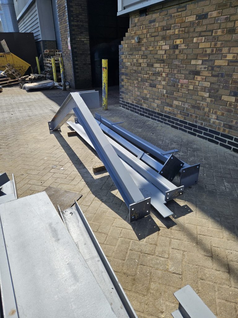 steel cutting, steel stock, fabrication bay, welding steel, drilled plates, end plates, steel priming, sandblasted steel, steel transport, steel fixings, site delivery, structural frame